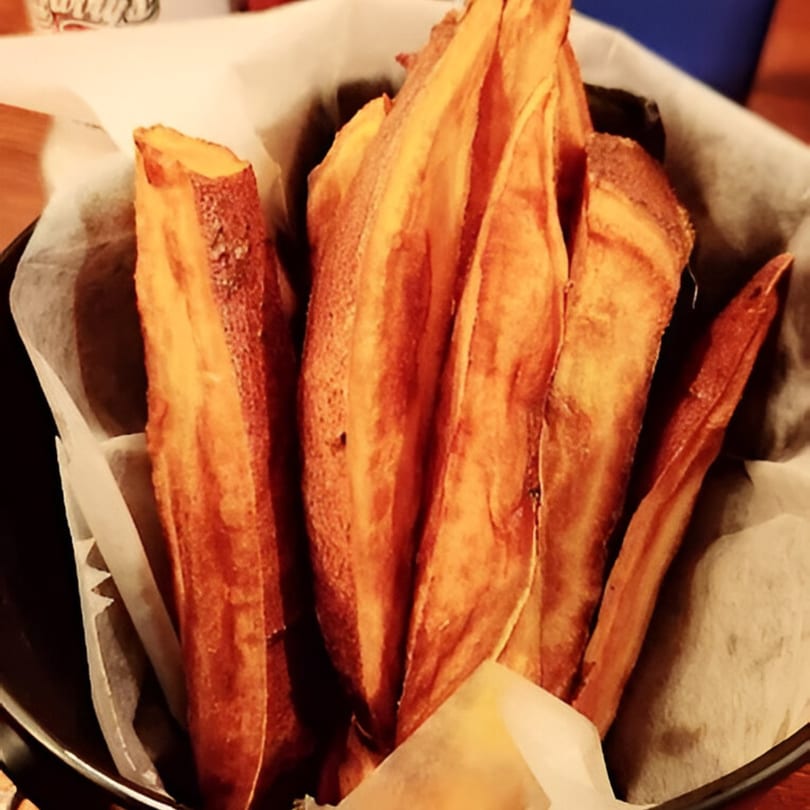 A basket of crispy, golden-brown sweet potato fries from Rustic Tables Restaurant & Bar.